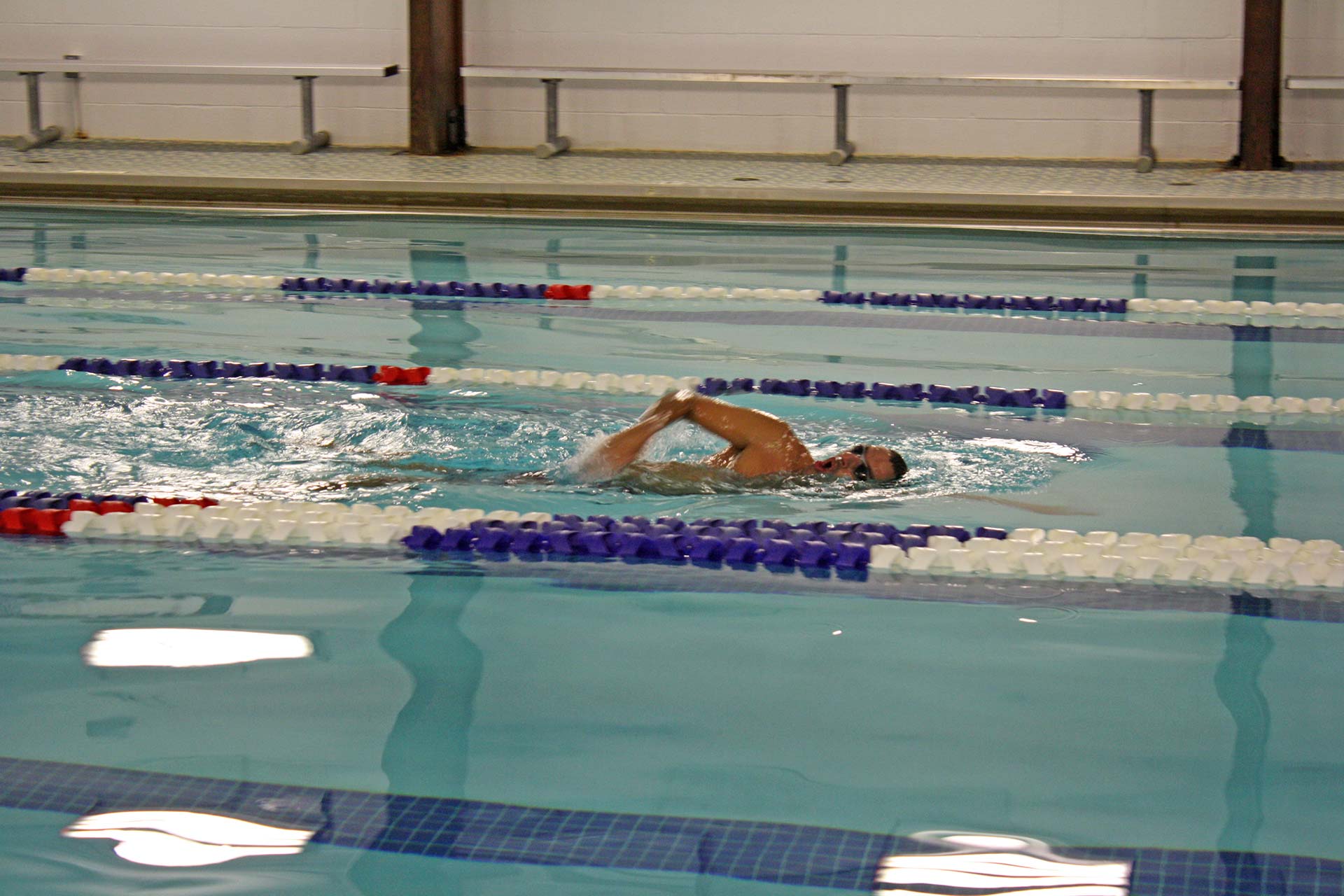 Man swimming laps in pool